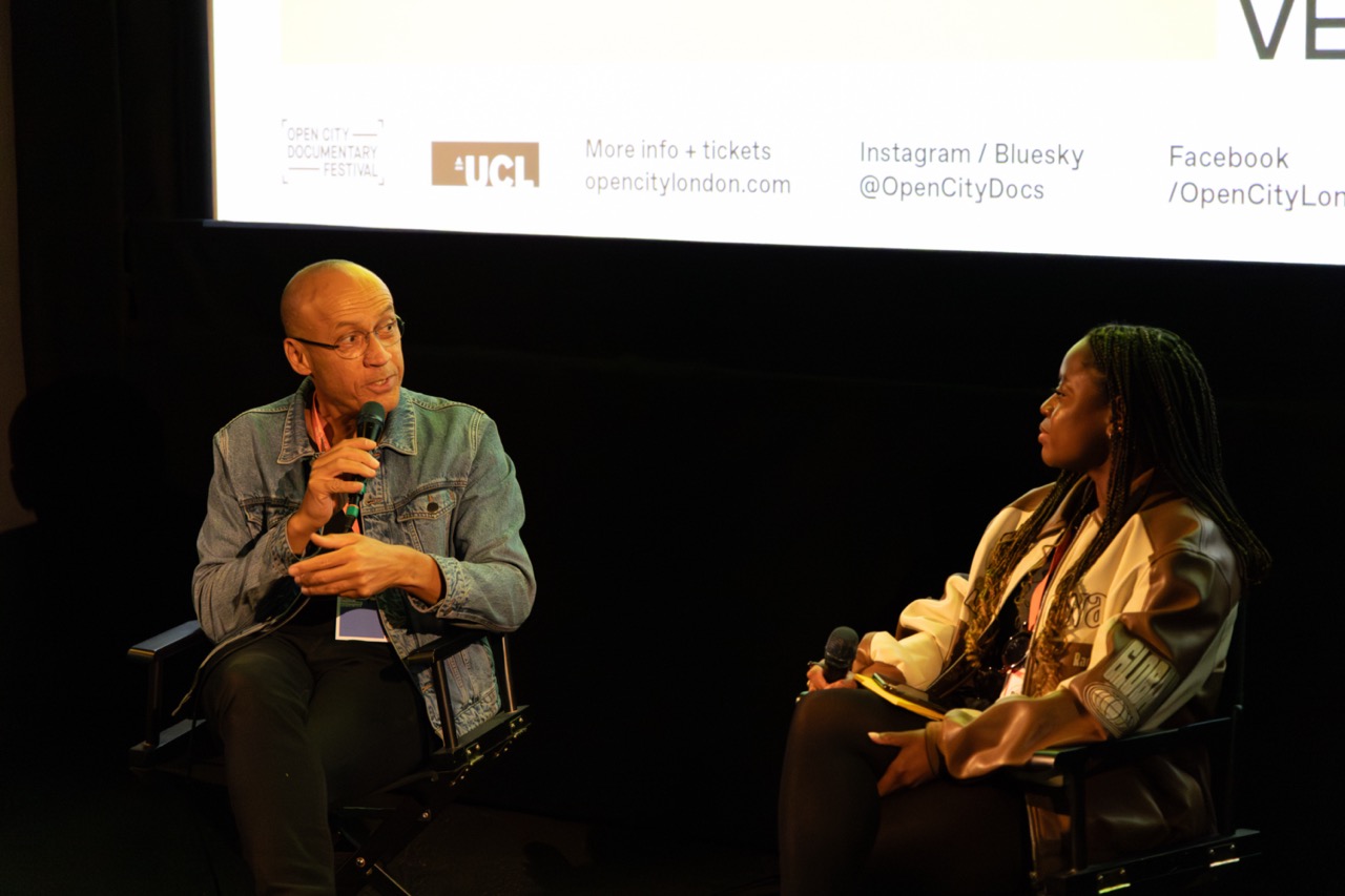 A speaker and guest in conversation at a documentary festival